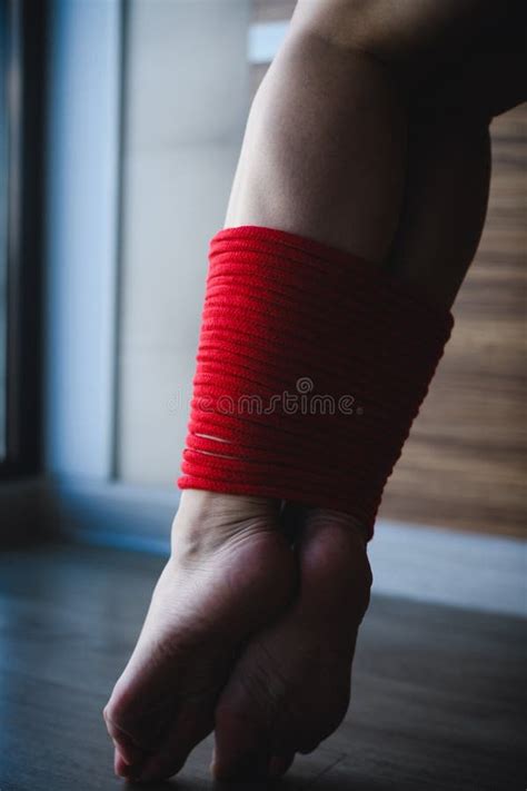 Close Up Of Female Ankles Tied With Red Rope Stock Image Image Of