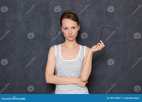 Portrait Of Serious Focused Girl Wearing Taking Off Her Glasses Stock Image Image Of Gray