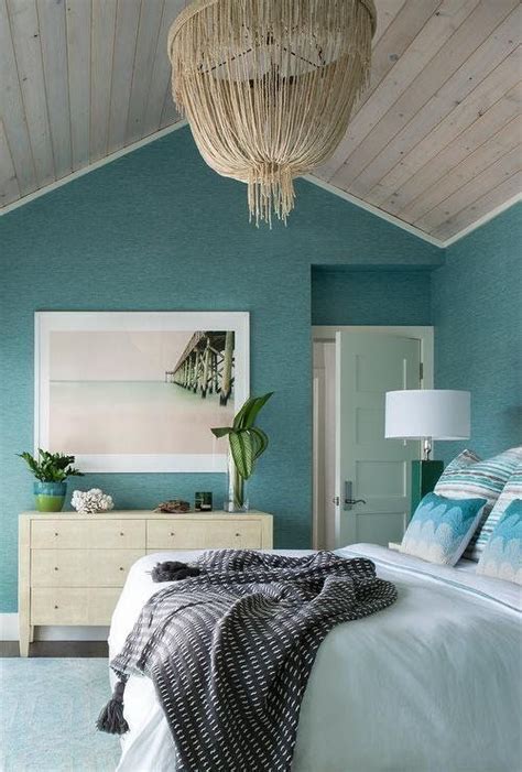 Coastal Bedroom With A Ocean Colored Walls And Beach Decor