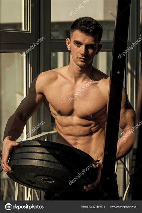 Fitness Instructor Sportsman Athlete With Muscles Holds Weight Plates