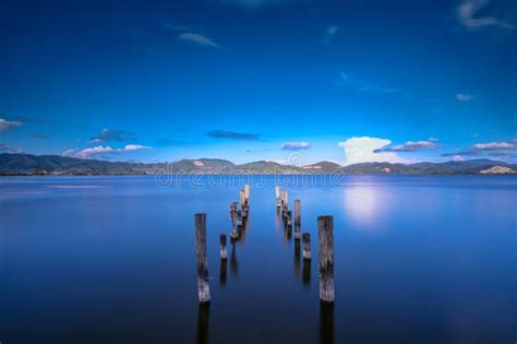 Wooden Pier Or Jetty And A Boat On A Lake Sunset Versilia Tuscany