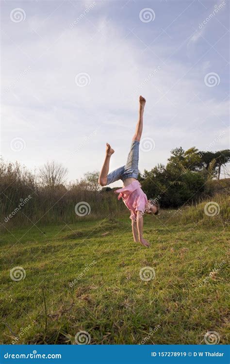 Boy In Nature Doing A One Hand Handstand Stock Image Image Of Cute