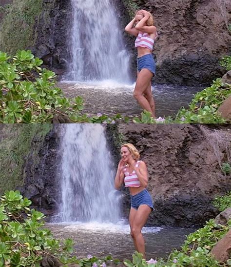 A Woman Standing In Front Of A Waterfall Talking On A Cell Phone While