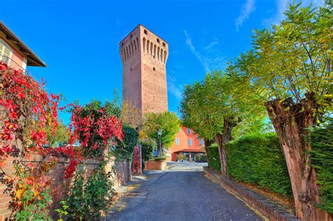 Alley And Red Tall Medieval Tower In Piedmont Italy Stock Image