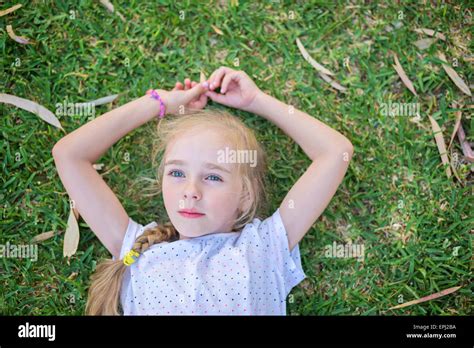 Caucasian Little Girl Lay On Grass Stock Photo Alamy