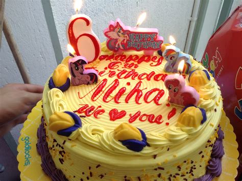 A Yellow Birthday Cake With Candles On It