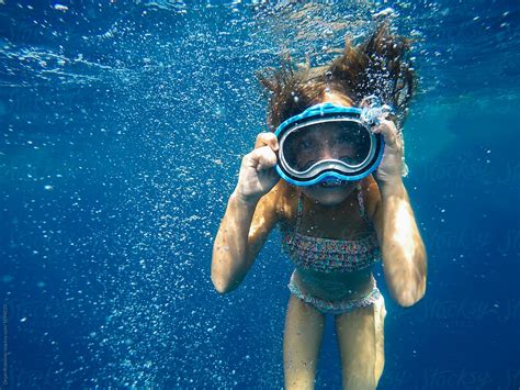 Girl Diving In To Deep Blue Water Stocksy United