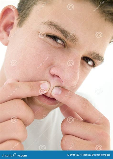 Teenage Boy Popping Zit On Face Stock Photography | CartoonDealer.com