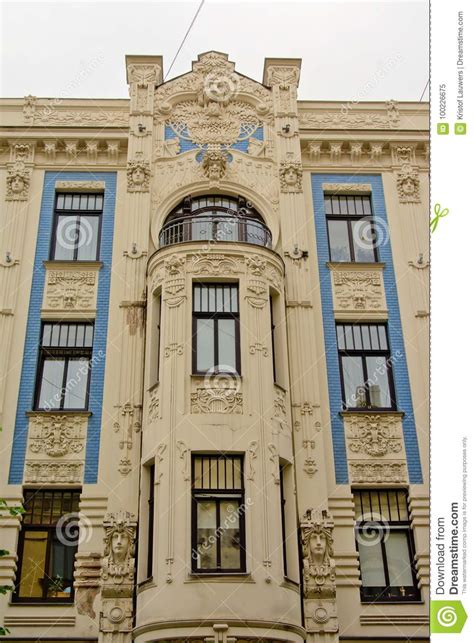 Detail Of Facade Of Art Deco Buildlding With Faces And