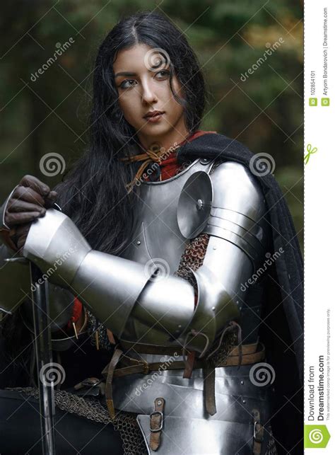 A Beautiful Warrior Girl With A Sword Wearing Chainmail And Armor In A