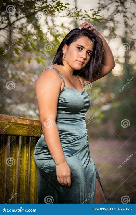 Beautiful Hispanic Model Posing In A Green Dress Outdoors During