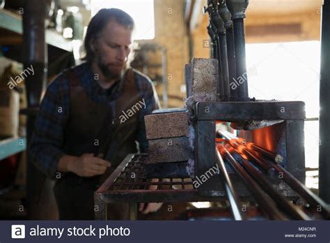 Blacksmith Heating Iron In Blacksmith Shop Stock Photo Alamy