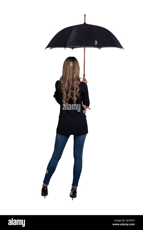 Back View Of Woman Stands And Holding An Umbrella Over Her Head On