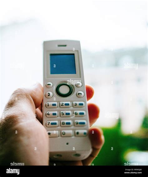 Man Hand Holding Outdoor Home Office White Cordless Phone Dialing A