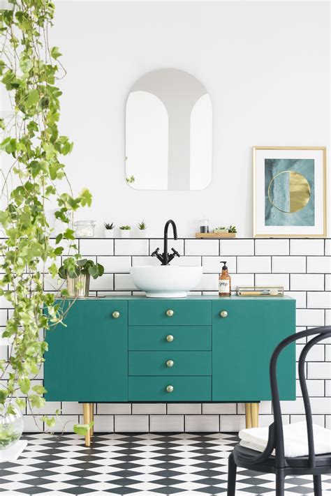 A light pastel blue muted with touches of gray, like the two tones that are joined in the cabinets and walls of this kitchen. 11 Ways to Use Benjamin Moore's 2021 Color of the Year Aegean Teal