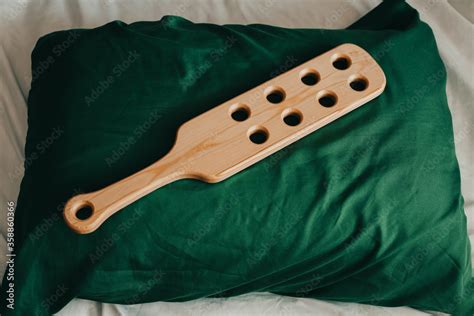 Wooden Paddle On The Pillow Prepared For Spanking Domestic Discipline