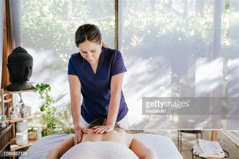 woman giving massage photos and premium high res pictures getty images