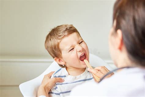 Pediatrician Examines Child With Sore Throat Stock Photo Image Of