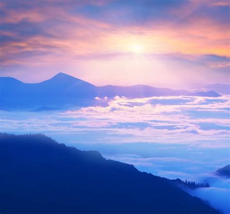 Misty Clouds In The Mountains At Sunrise Stock Photo Image Of