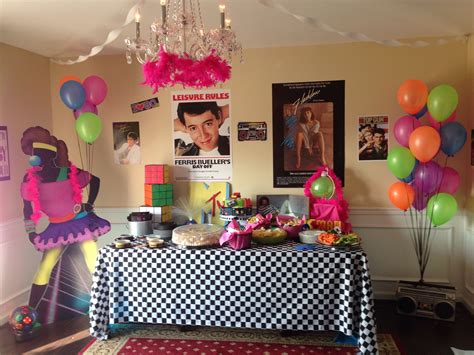 A Birthday Party With Balloons Cake And Pictures On The Wall In The