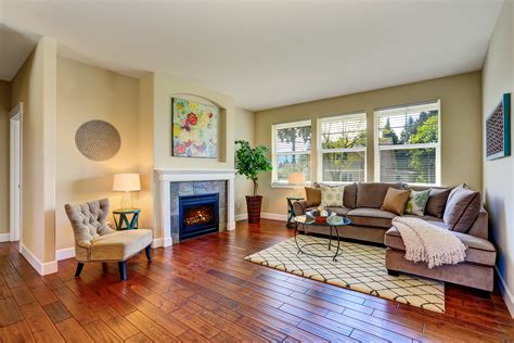 Cozy Living Room With Fireplace Beige Walls And Hardwood Floor