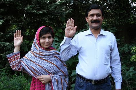 Malala Yousafzai And Her Father Ziauddin Raise Their Hands To Support