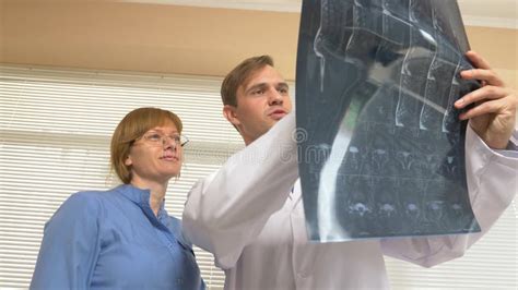Doctors A Man And A Woman Analyze The Results Of Mri X Ray Images The Results Of Magnetic