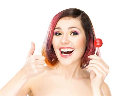 Attractive Smiling Girl Thumbing Up With A Chupa Chups Stock Image