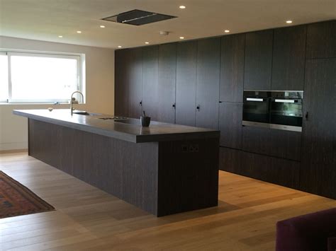 What do stainless steel island worktops look like? Solid wood kitchen with concrete worktop, eye-level ovens ...