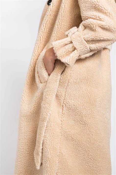 Vertical Shallow Focus Shot Of A Female Wearing A Fluffy Beige Bathrobe Stock Image Image Of