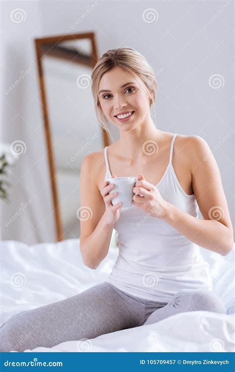 Joyful Woman Kneeling On Bed And Holding Cup Of Coffee Stock Image Image Of Healthy Leisure