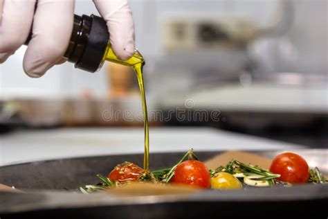 Food Concept Chef Is Pouring Olive Oil Over Fresh Salad In Restaurant