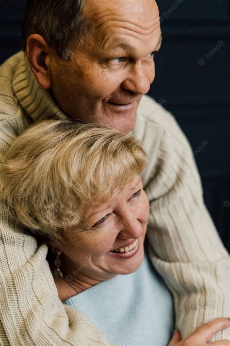 Premium Photo Portrait Of Old Couple Wife And Husband Hugging And Smiling Dark Blue