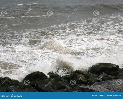 Rocky Seashore With Waves Hitting Creating Foam And Splashing Stock