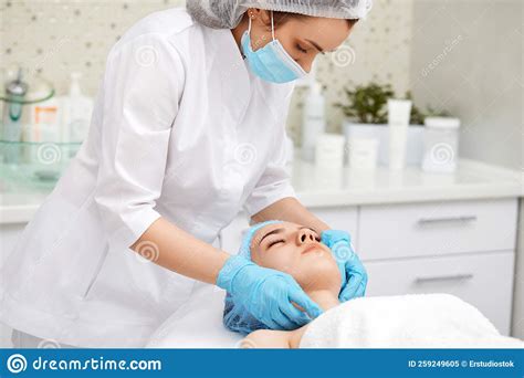 Young Beautiful Woman Receiving Facial Massage Spa Stock Image Image Of Head Blue 259249605
