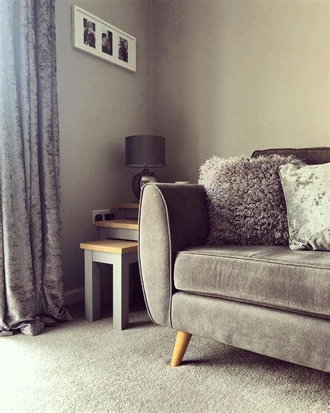 a living room with a couch, table and lamp in it's centerpiece