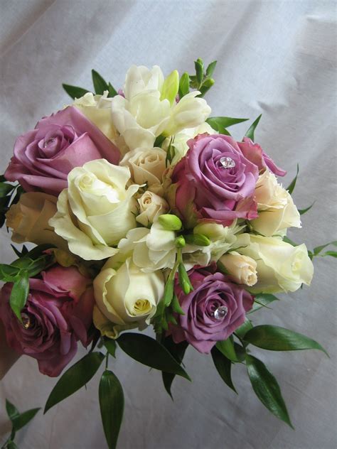 Order flowers online with us and send them to the doorstep of your father. Purple and white Rose and Freesia Bridal Bouquet ...