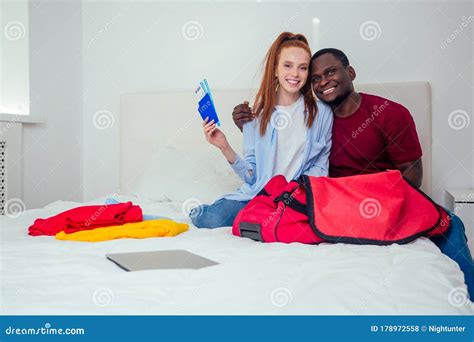 Latin Hispanic Man And Redhaired Ginger Woman Unpacking In New House
