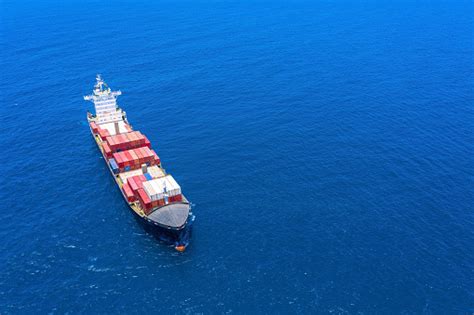 Large Loaded Container Ship Cruising Slowly At Sea Stock Photo