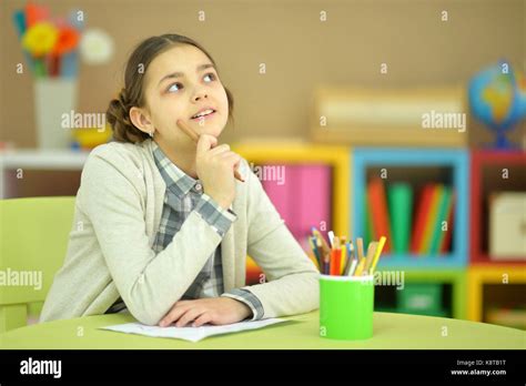 Thoughtful Teen Girl Sitting At Table In Her Room Stock Photo Alamy