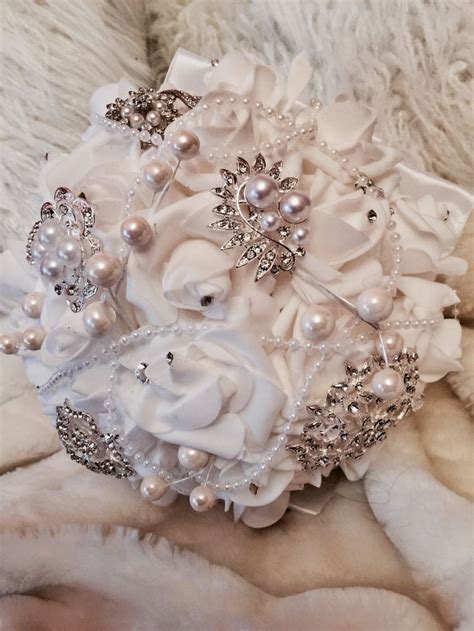 A brooch bouquet would be perfect for those of you jetting off to take your vows. White brooch bouquet | White brooch bouquet, Wedding ...