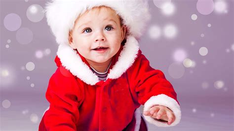 Smiley Cute Baby Boy Is Crawling On Floor Wearing Santa Dress In