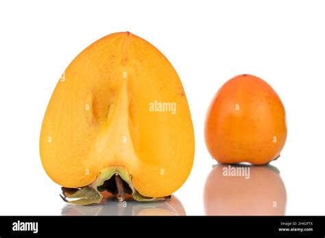 One Whole And One Half Sweet Organic Persimmon Close Up Isolated On