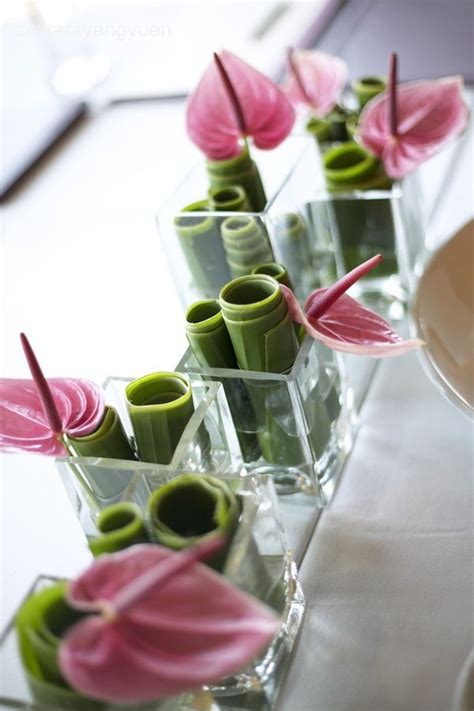 Small Vases Filled With Pink And Green Flowers