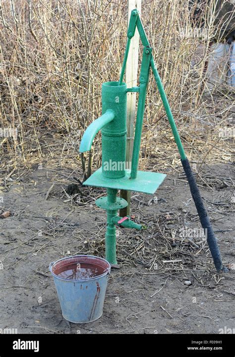 Hand Pump Leading To An Artesian Well Pumping Water For Watering The