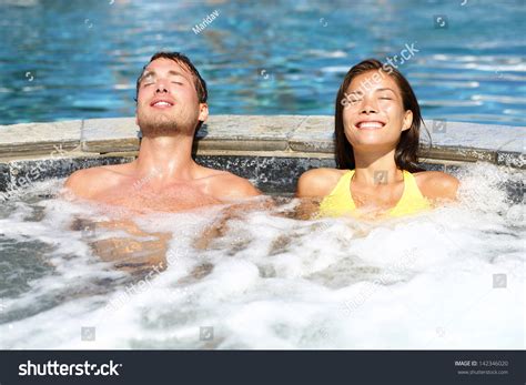 Spa Couple Relaxing Enjoying Jacuzzi Hot Tub Bubble Bath Outdoors On Romantic Summer Vacation
