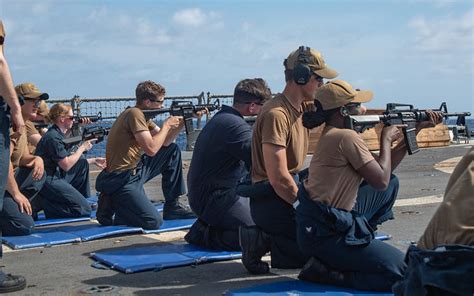 Sailors Fire M4 Rifles During A Small Arms Qualification Onboard Uss