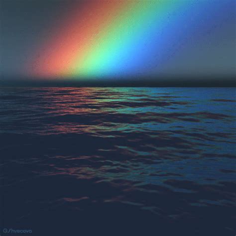A Rainbow Is Seen Over The Ocean At Night
