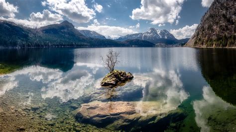 Download Wallpaper 1366x768 Lake Reflection Stones Tree Mountains