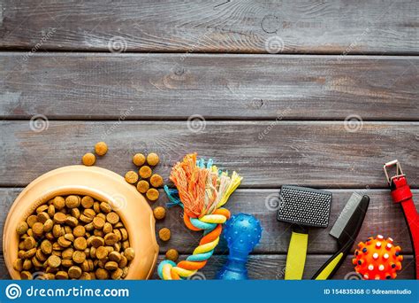 Dry Dog Food In Bowl And Toys On Wooden Background Top View Mock Up